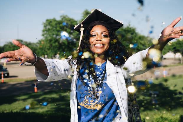 Happy graduate in cap and gown 